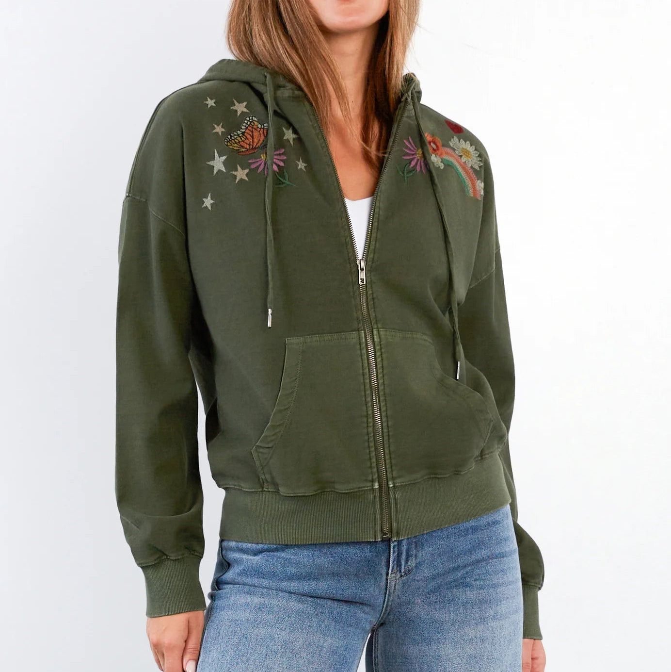 Woman wearing a green hoodie with embroidery on a white background